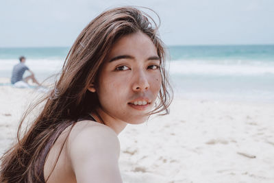 Portrait of beautiful young woman on beach