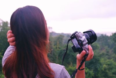 Rear view of woman photographing