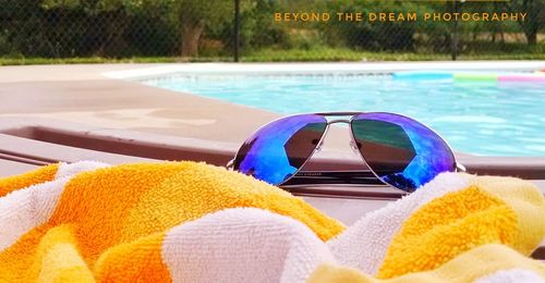 Close-up of sunglasses on swimming pool