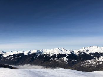 Scenic view of snow covered mountains against sky