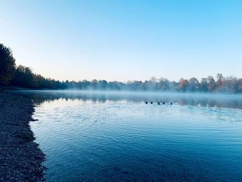 Scenic view of lake against clear blue sky