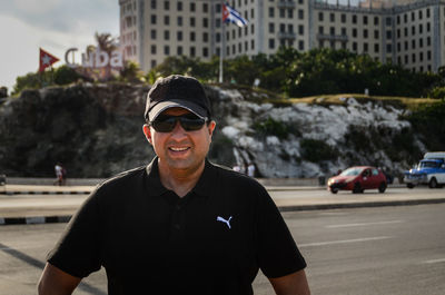 Portrait of smiling man standing in city