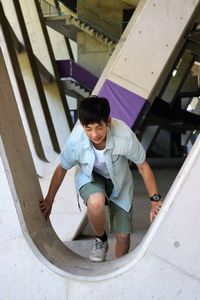 Full length portrait of boy on railing