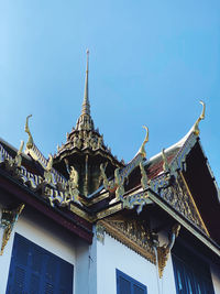 Low angle view of temple building against clear blue sky