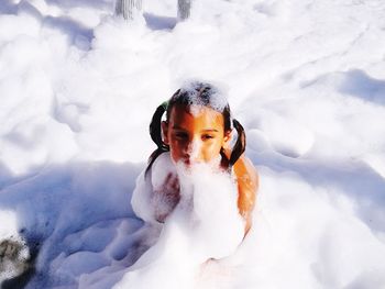 High angle view of girl sitting in surf