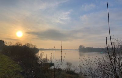 Scenic view of lake against sky during sunset