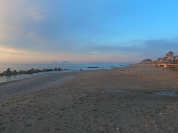 Scenic view of beach against sky during sunset