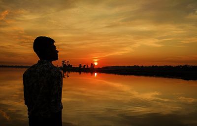 Scenic view of water against sky during sunset