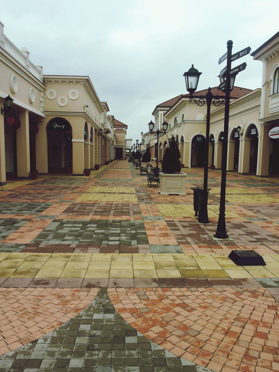 building exterior, architecture, built structure, cobblestone, the way forward, sky, street, paving stone, city, footpath, diminishing perspective, incidental people, empty, in a row, walkway, sidewalk, outdoors, day, residential structure, building