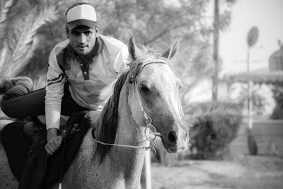 Portrait of man riding horse