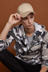 Portrait of young man sitting in hat