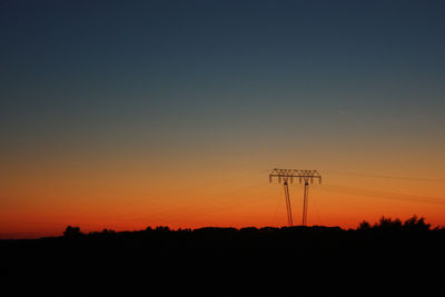 Silhouette landscape against clear sky during sunset