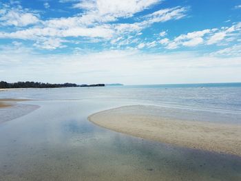 Scenic view of beach against blue sky