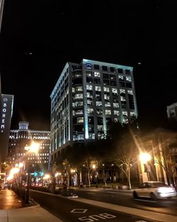 Illuminated city street at night