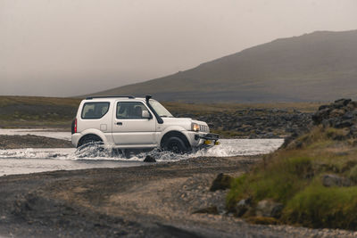 Small 4x4 crossing river, landmannalaugar highlands in iceland