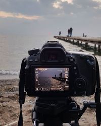 Photographer photographing against sky