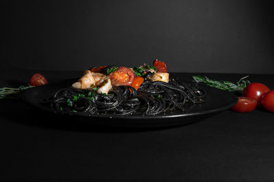 Close-up of vegetables in bowl against black background