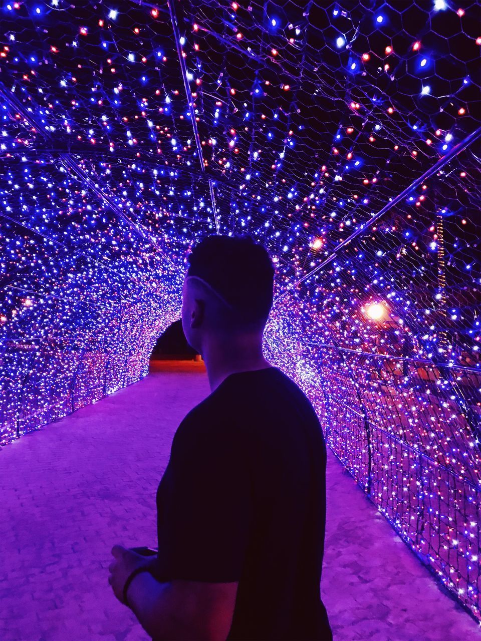 REAR VIEW OF SILHOUETTE MAN STANDING ON ILLUMINATED STAGE