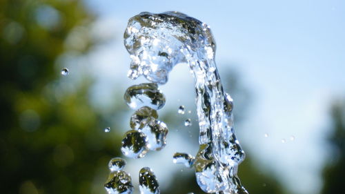 Close-up of water drop against sky