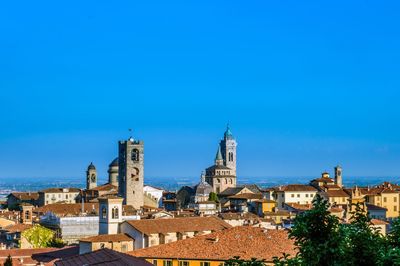 View of cityscape against blue sky