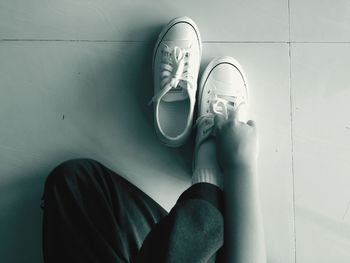 Low section of woman standing on tiled floor