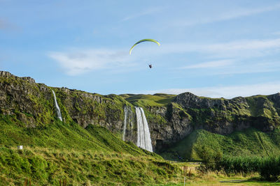 Low angle view of man over mountain against sky