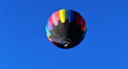 Low angle view of hot air balloon against blue sky