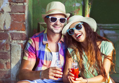 Portrait of smiling young woman wearing sunglasses