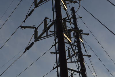 Low angle view of electricity pylon against sky