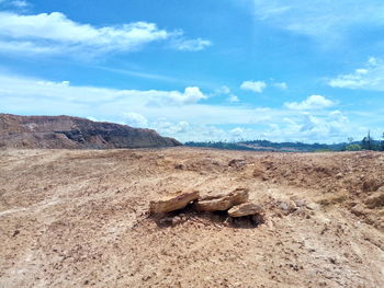 Scenic view of rocks on land against sky