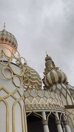 Low angle view of building against cloudy sky