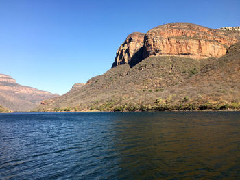 Scenic view of mountain against blue sky