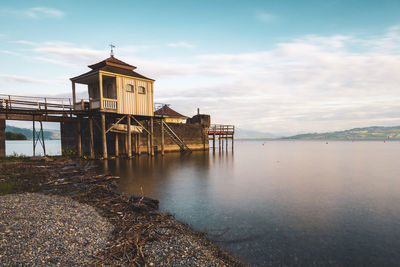 Building by sea against sky