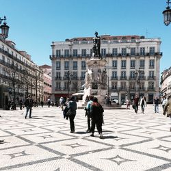 People walking in front of built structures