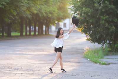 Full length of woman standing on footpath