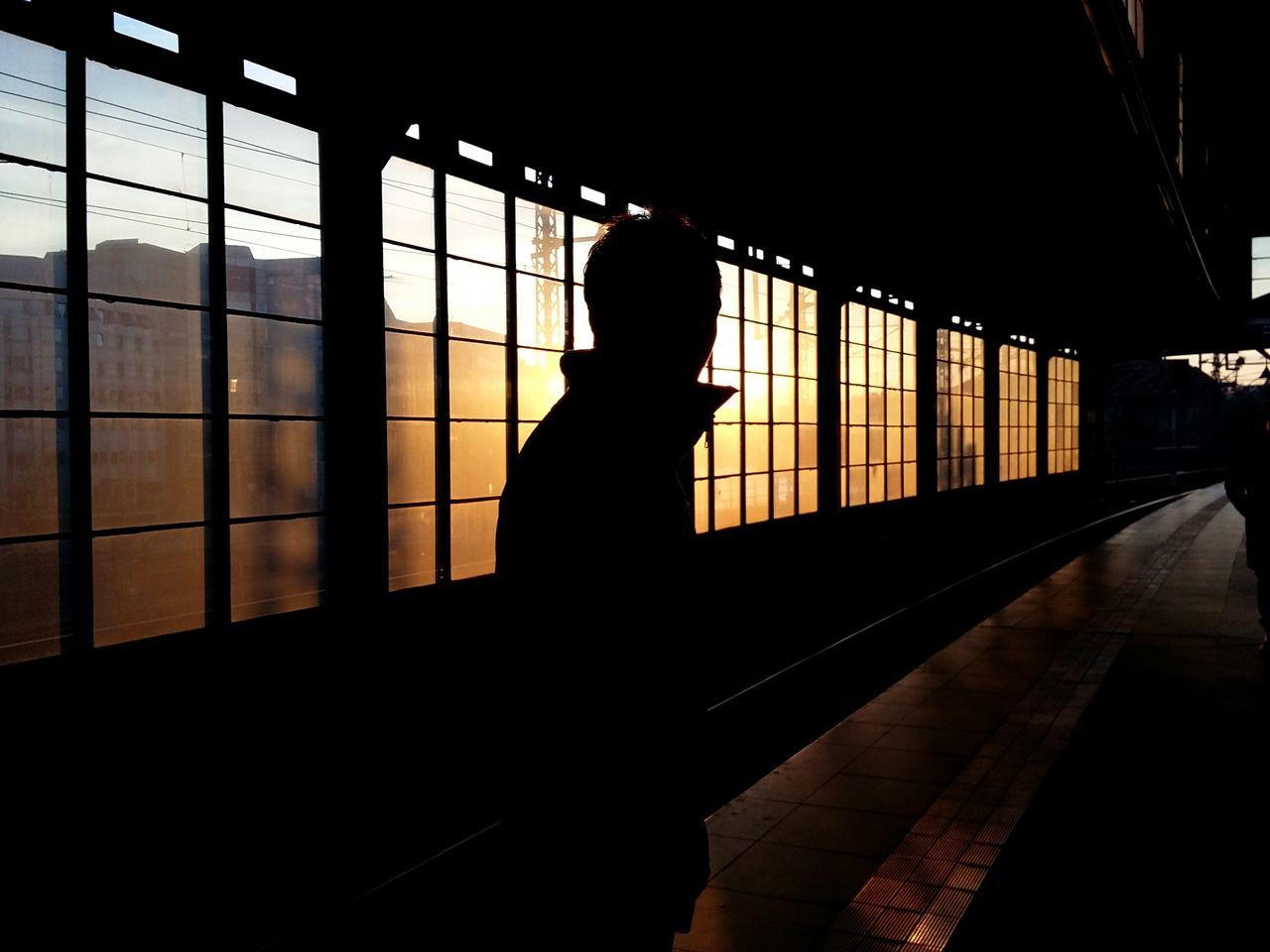 friend in the sunset. · Berlin germany 030 metro station train station Against the light light and shadow Silhouette Silhouettes darkness and light Architecture Metal beams simplicity Urban geometry