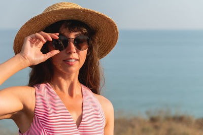 Young woman wearing hat at beach
