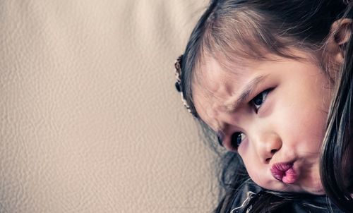 Close-up portrait of cute girl looking away