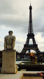 Low angle view of eiffel tower against cloudy sky