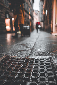 Blurred motion of people walking on footpath in city