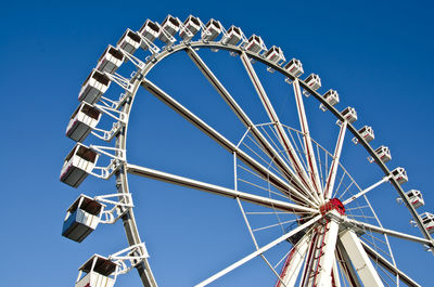 Low angle view of ferris wheel against clear sky