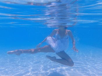 View of ballet dancer underwater in pool