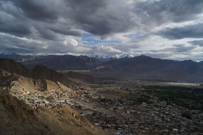 Scenic view of mountains against cloudy sky