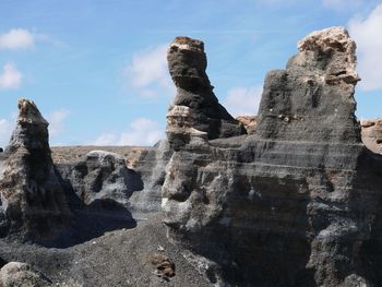 Low angle view of rock formation against sky