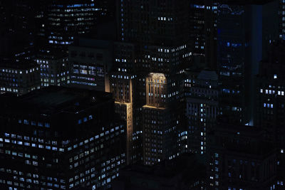 Illuminated modern buildings in city at night