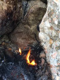 High angle view of bonfire on rock