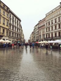 People in town square against sky