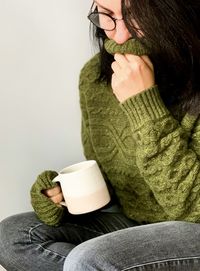 Autumn. young woman drinking coffee to warm up. autumnal mood, young woman is drinking coffee or tea