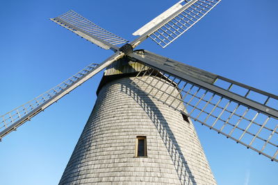 Historical windmill against blue sky 