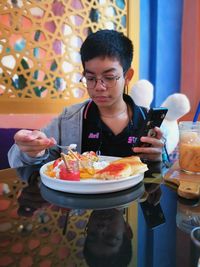 Rear view of woman having food